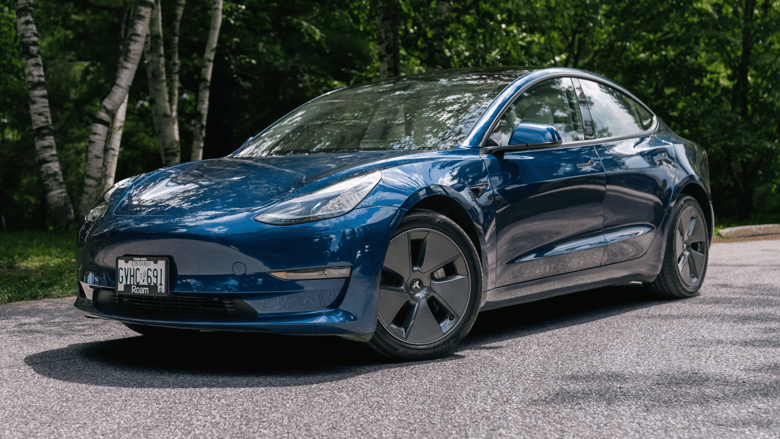 Blue premium electric sedan parked outdoors